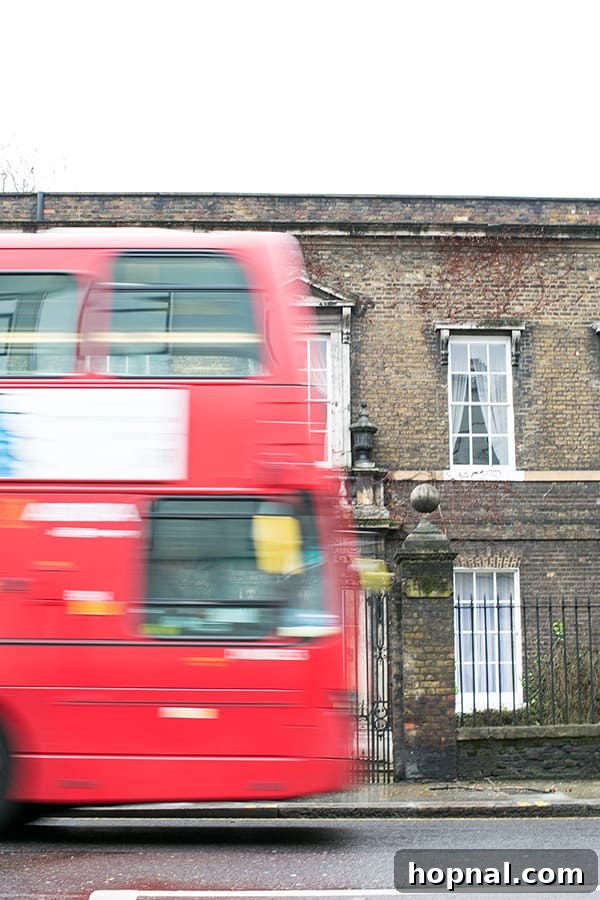 A red double-decker bus on a busy London street