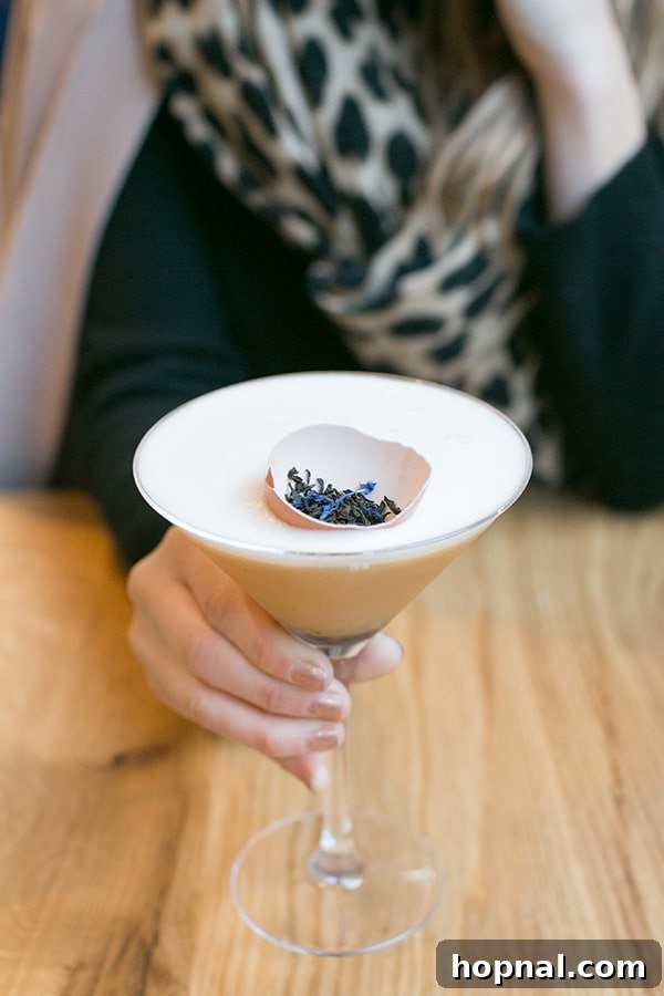 A woman enjoying a martini in a stylish London setting