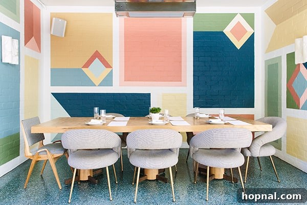 The charming outdoor eating area at Viviane, featuring a distinct colorful block wall, perfect for al fresco dining.