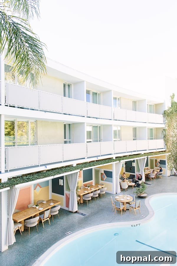 A view of the elegant dining room at Viviane in the Avalon Hotel Beverly Hills, showcasing Mid-Century Modern interior design with a focus on light and comfort.