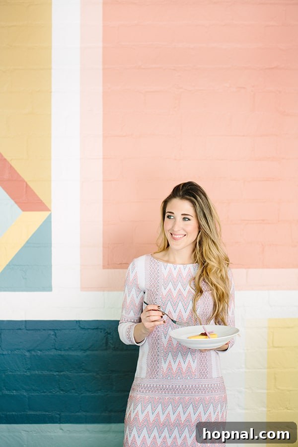 A guest enjoying a meal at Viviane, seated in front of a colorful, stylish wall, capturing the restaurant's vibrant atmosphere.