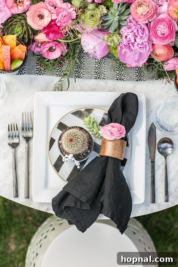 Spice Up Your Cinco de Mayo Celebration 17 Cinco de Mayo table setting with black napkin, wooden napkin ring, pink flowers and black flatware.