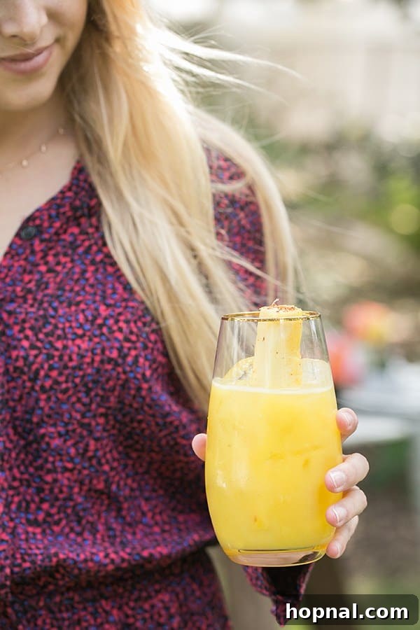 Spice Up Your Cinco de Mayo Celebration 9 Girl holding a pineapple cocktail