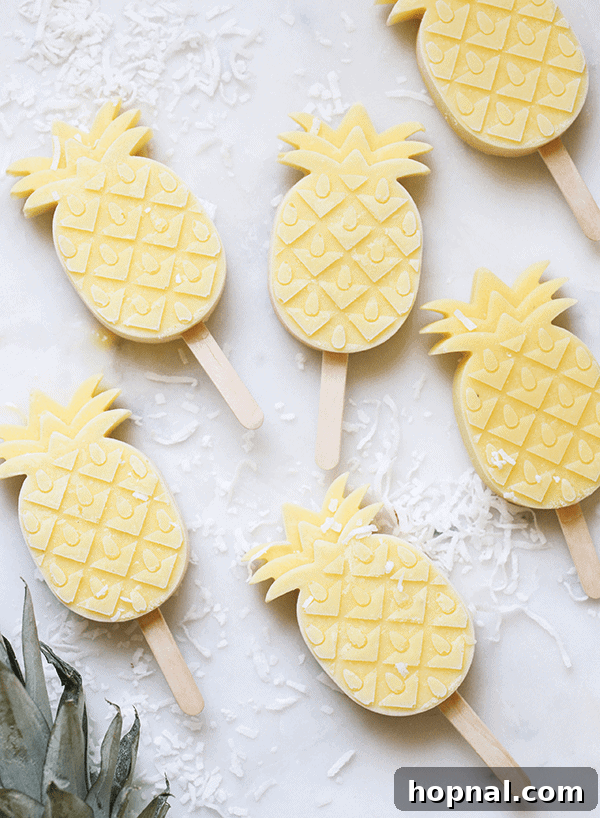 Pineapple popsicles on a marble table.