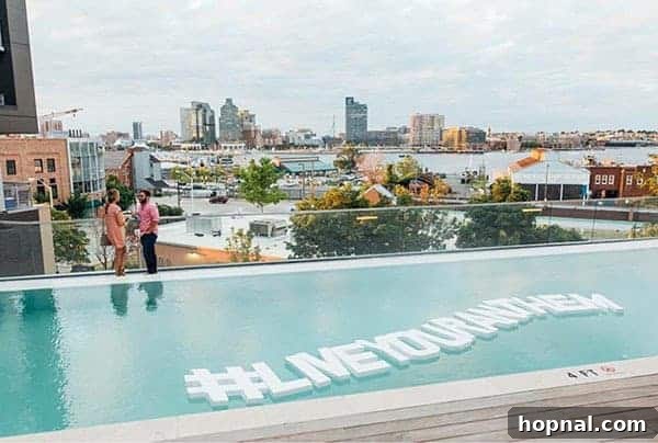 Large pool letters floating in a pool over looking the city 