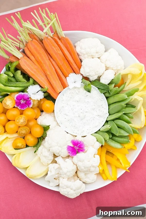 Fresh vegetables and dip on a pink pillow.