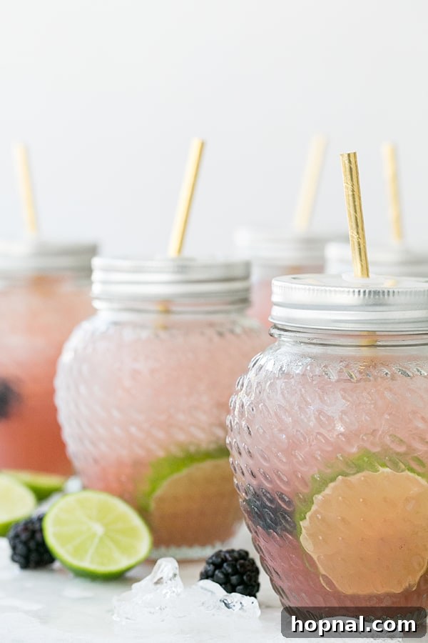 close up of blackberry margaritas in jars - fresh blackberries