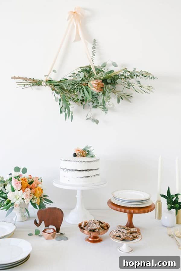 10 Picture-Perfect Baby Shower Celebrations 3 Elegant white cake on a minimalist stand, serving as a focal point for a Simple and Sweet Modern Baby Shower theme, surrounded by understated decor.