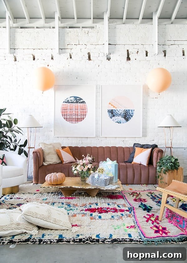 10 Picture-Perfect Baby Shower Celebrations 5 Cozy and stylish autumn-themed baby shower setup featuring a comfortable pink couch, an assortment of balloons in fall colors, and a vibrant colorful rug, perfectly capturing a modern fall aesthetic.