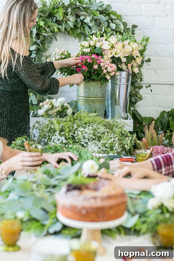 Greenery and Good Times Wreath Party 9 Guest carefully selecting beautiful flowers from a pale to add to their holiday wreath
