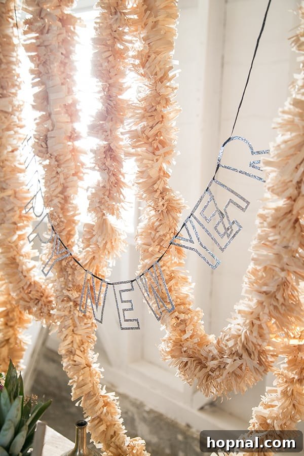 A festive New Year's Eve sangria bar setup, featuring a large gold fringe garland as a backdrop, a 'Happy New Year' sign, and elegant floral arrangements, creating a chic party atmosphere.