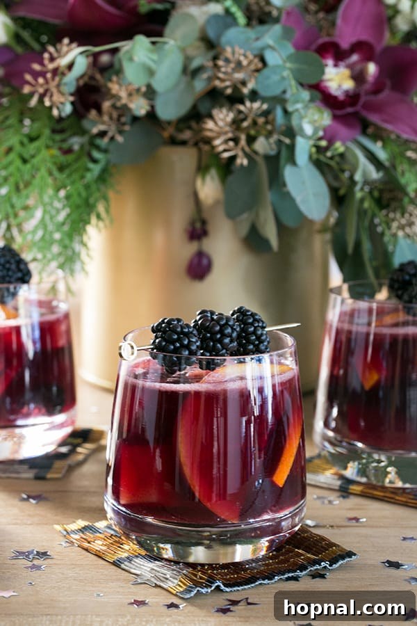 A close-up shot of a glass of red sangria, artfully garnished with fresh blackberries, reflecting the festive and sophisticated essence of the drink.