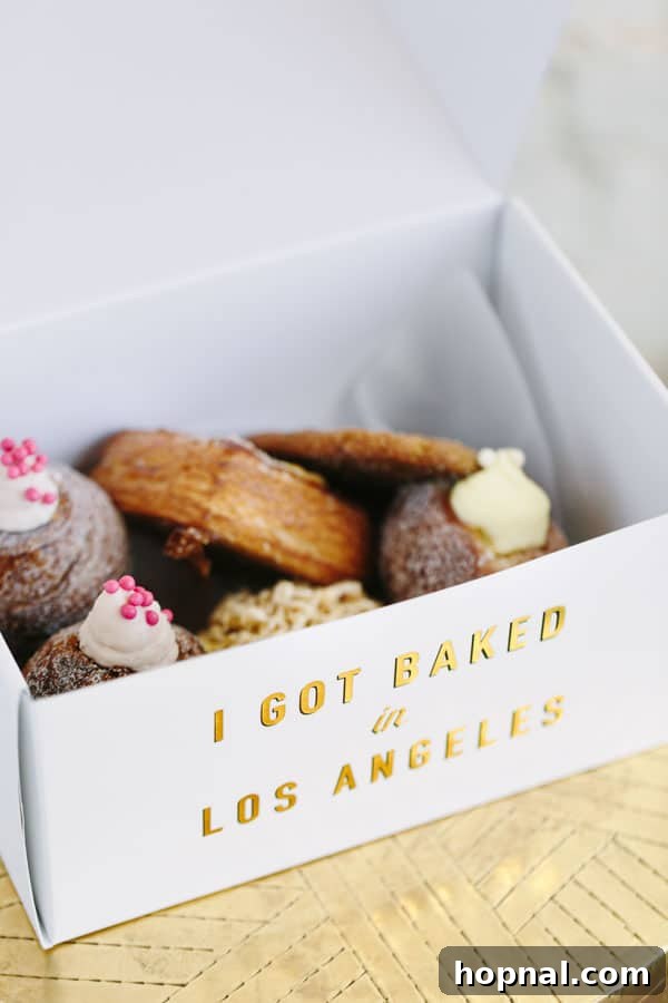 A curated selection of delicious treats displayed in a bakery box from Mr. Holmes Bakehouse, ready to be enjoyed.