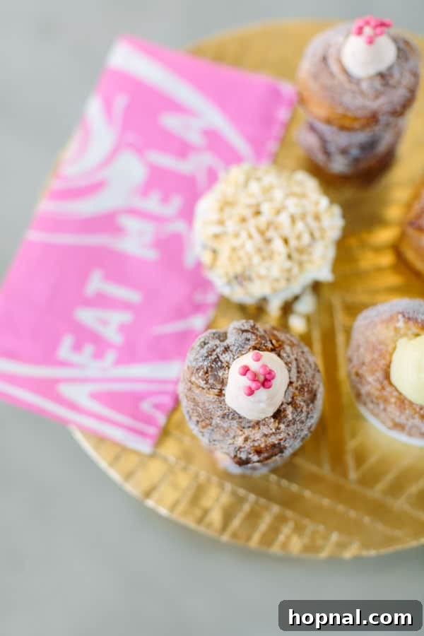 A close-up shot of the famous Cruffin from Mr. Holmes Bakehouse, perfectly golden and inviting.