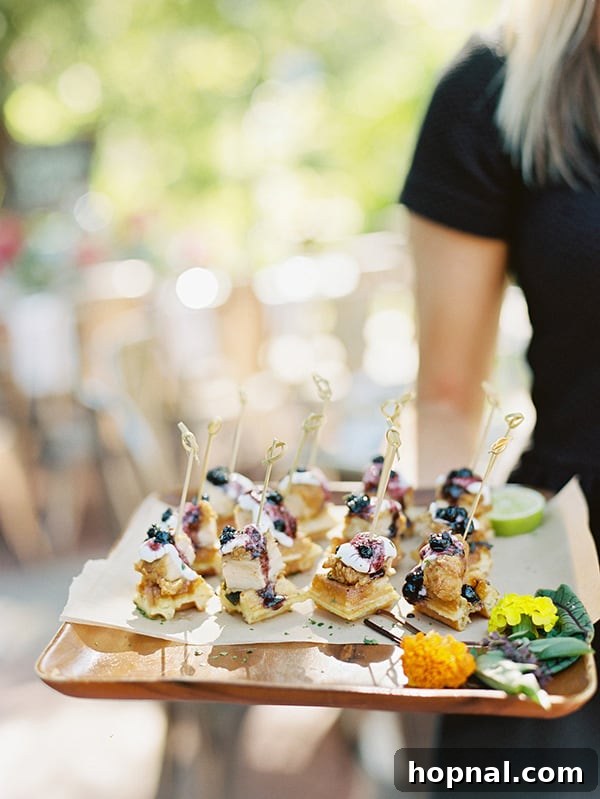 Chicken and waffles on a tray at a wedding, illustrating a creative catering choice.