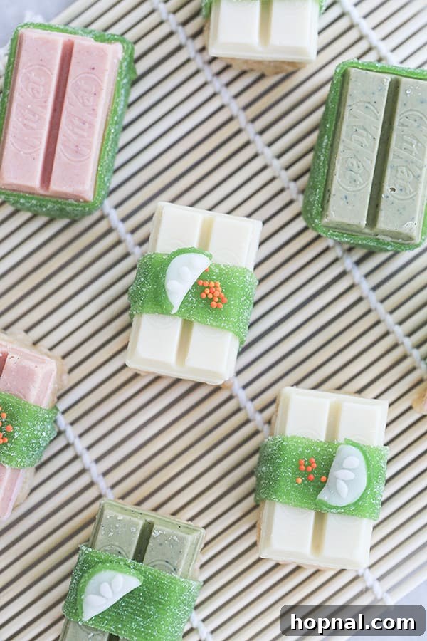 Sweet Sushi Delights with Kit Kat 7 Assembling Kit Kat candy sushi on a bamboo rolling mat, showing Rice Krispies 'rice' being topped with Kit Kats.