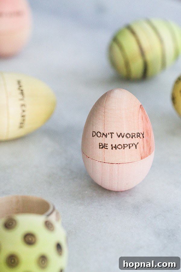 Heirloom Pyrography Easter Eggs 3 A pastel pink Easter egg with the phrase 'Don't worry be hoppy' burned onto its surface.