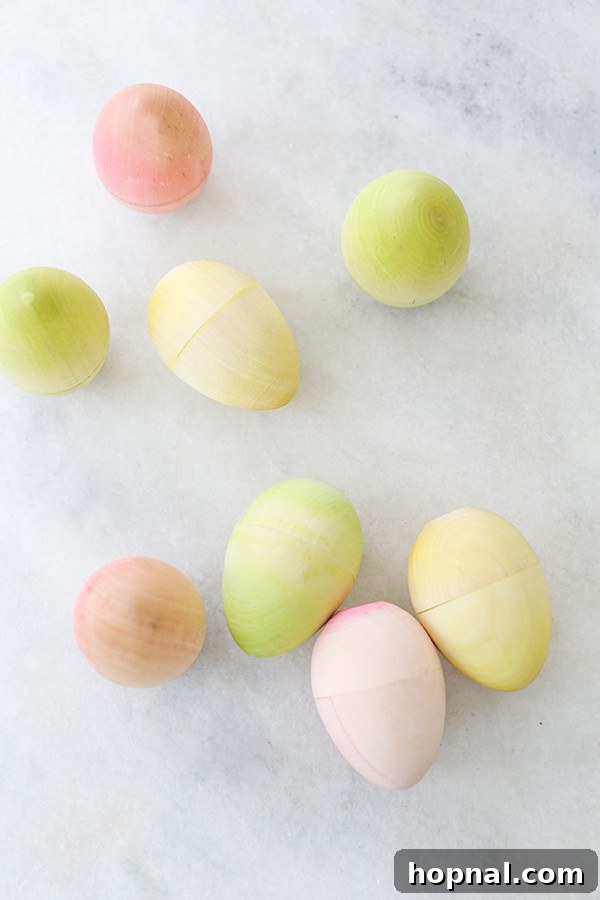 Heirloom Pyrography Easter Eggs 4 Soft pastel color Easter eggs arranged artfully on a marble table, showcasing their delicate hues.