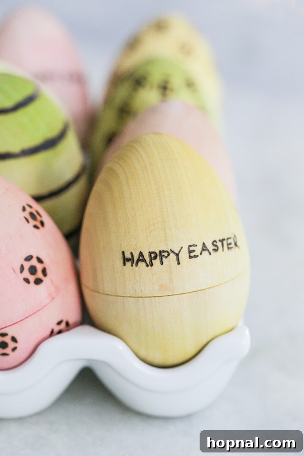 Heirloom Pyrography Easter Eggs 8 A vibrant yellow wooden Easter egg with 'Happy Easter' elegantly burned onto its surface.