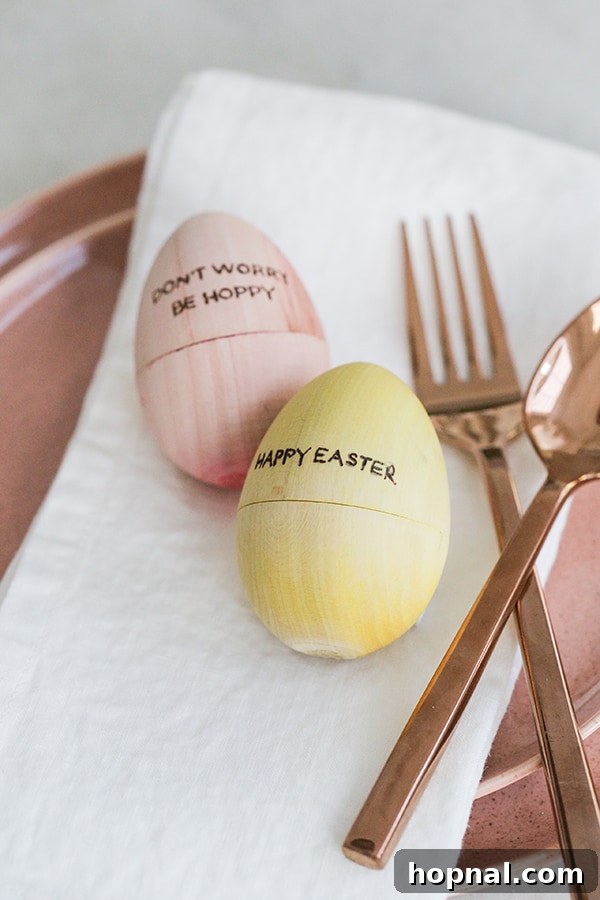 Heirloom Pyrography Easter Eggs 9 Two intricately wood-burned wooden Easter eggs, featuring unique letterings and patterns.