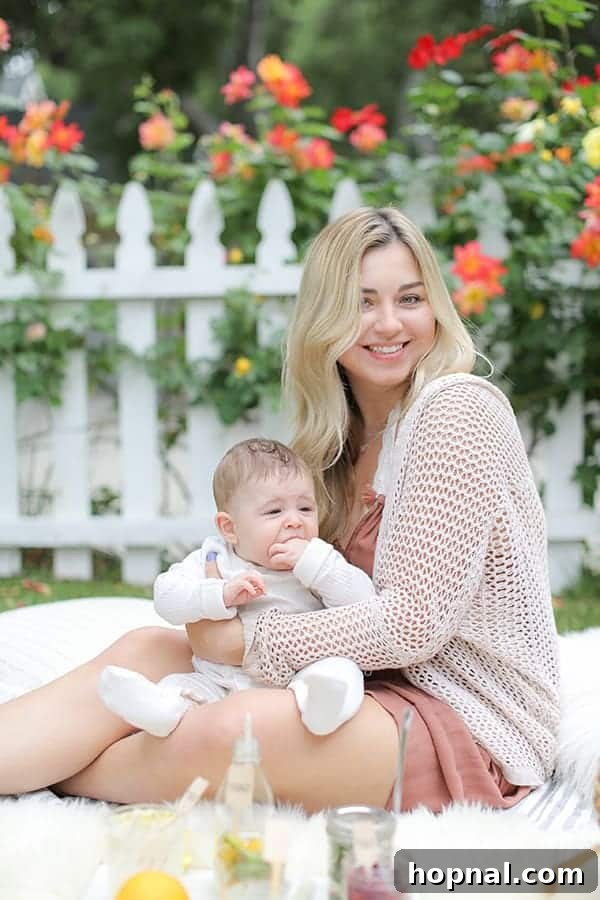 A beautifully decorated picnic setting with a variety of delicious food and refreshing drinks, perfectly arranged for a Mother's Day celebration.