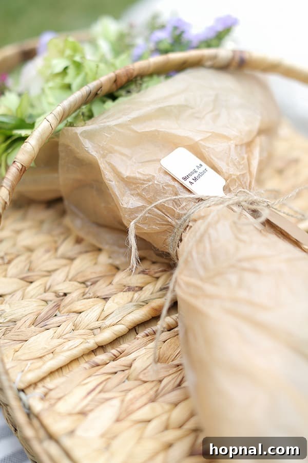 A beautifully adorned picnic basket, accented with a vibrant bouquet of fresh flowers, elegantly set on a blanket ready for a special outdoor occasion.