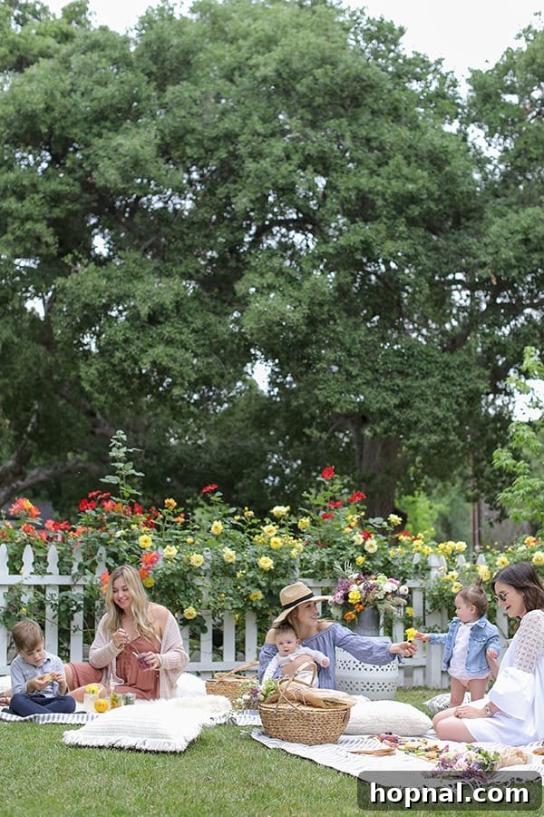 Happy women enjoying a festive Mother's Day picnic, laughing and sharing food outdoors in a picturesque park.