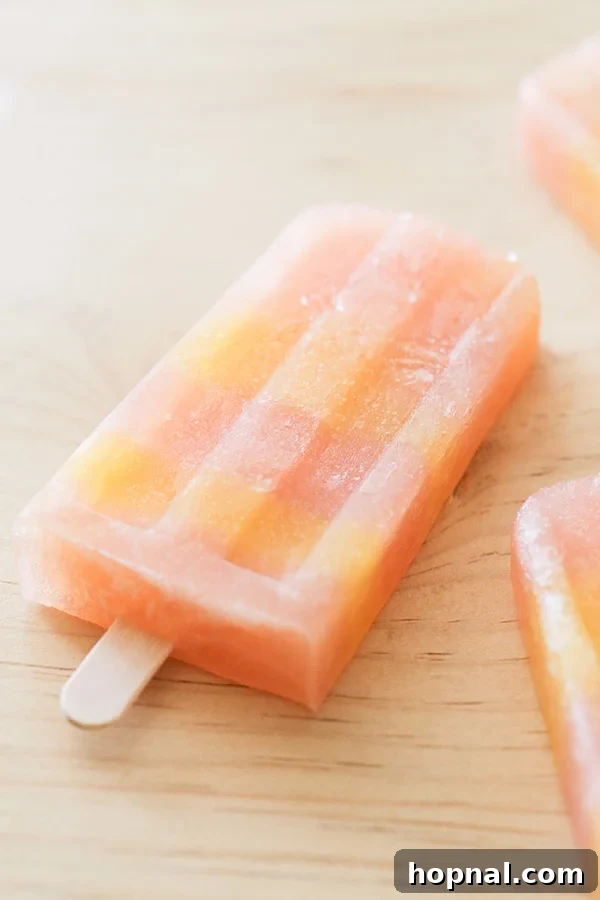 Boozy Greyhound Pops 2 A greyhound cocktail popsicles on a wooden table, vibrant and refreshing.