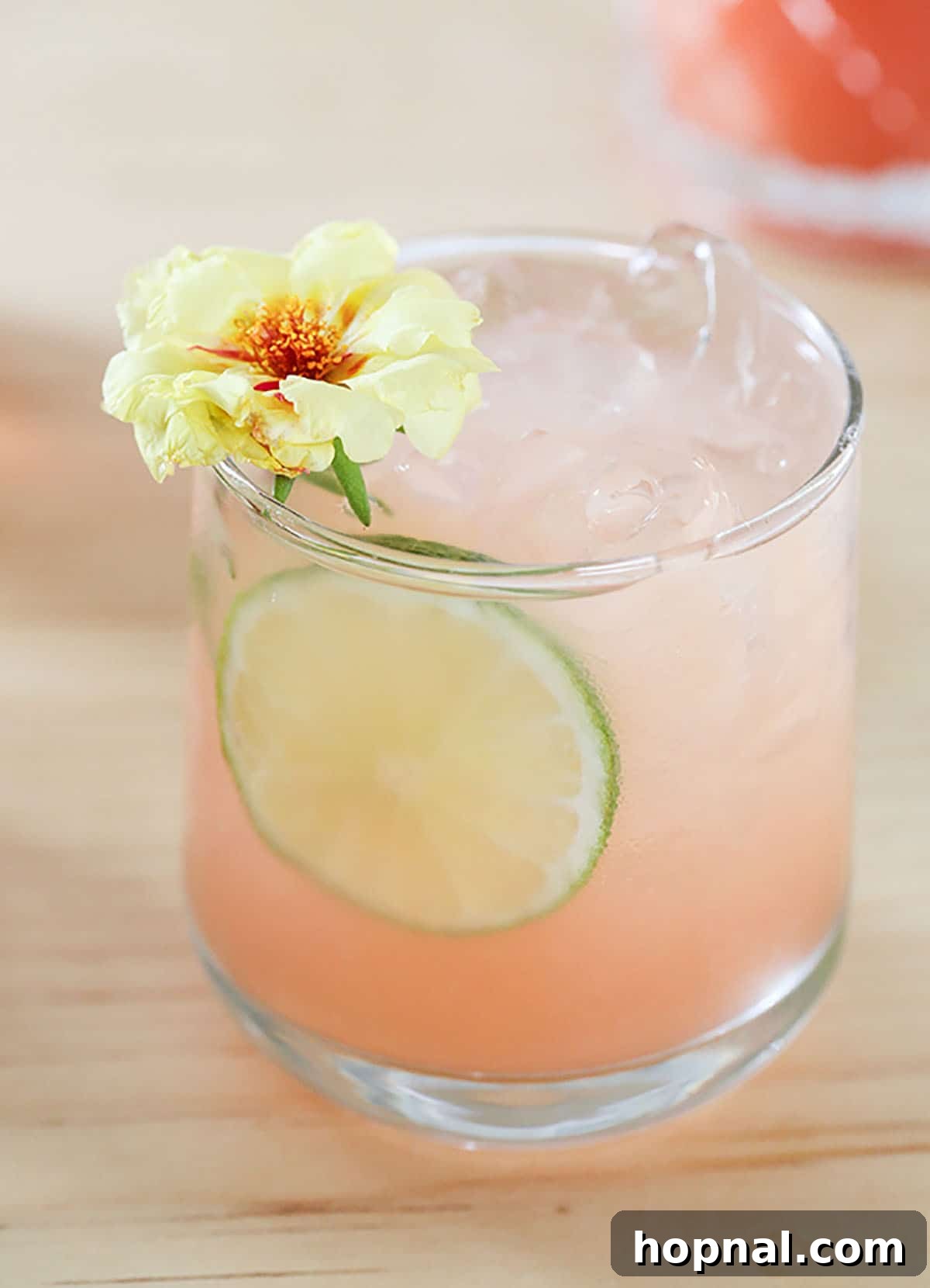 a cocktail garnish with flower - paloma cocktail recipe - fresh grapefruit juice