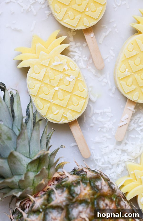 Close-up overhead shot of a single pineapple popsicle on a textured surface