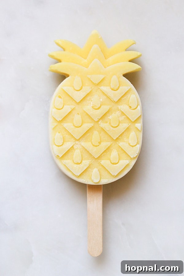 Close-up shot of an ice pop being carefully removed from a popsicle mold