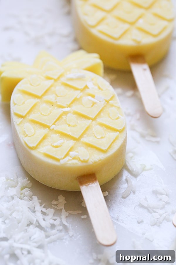 A single pineapple-shaped popsicle standing upright, showcasing its vibrant color