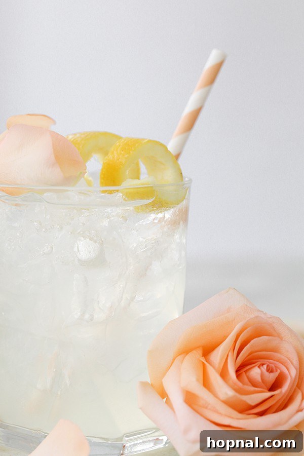 Petal Potion 6 Rose Water Cocktail featuring a stylish peach straw, ready for sipping.