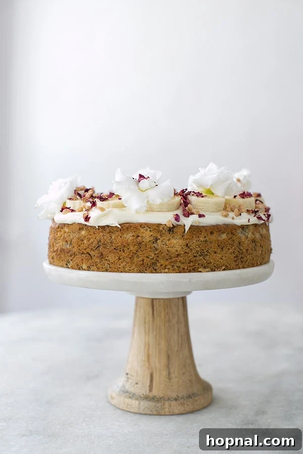 Super Moist Banana Cake Made with Oil 3 Beautifully decorated banana cake displayed on a elegant cake stand, ready to be served.