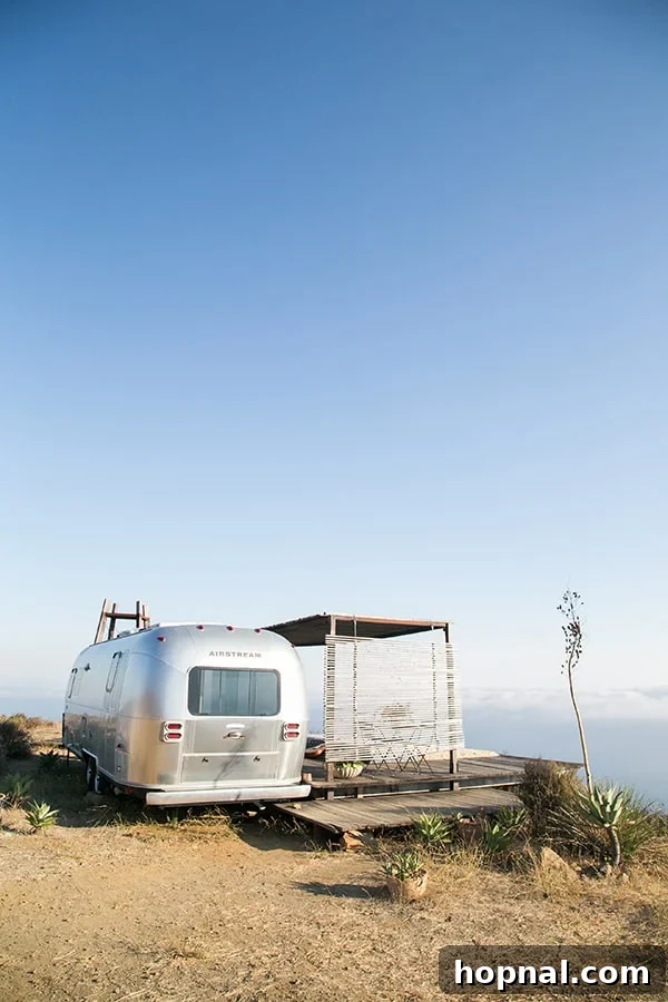 The Art of Airstream Entertaining in Malibu 14 The sleek Airstream nestled peacefully in the Malibu hills, showcasing its unique position overlooking the vast landscape.