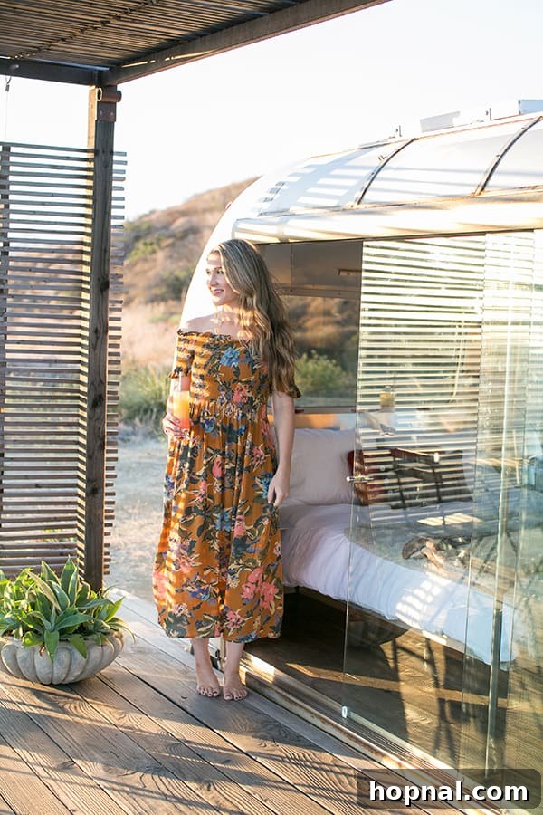 The Art of Airstream Entertaining in Malibu 3 Eden Passante standing proudly in front of a chic, renovated Airstream in Malibu, highlighting the unique luxury glamping setup.