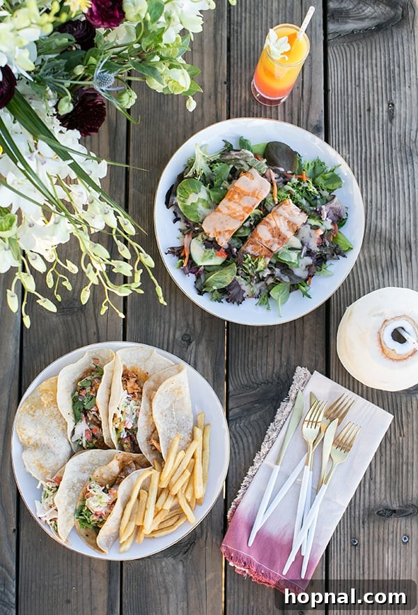 The Art of Airstream Entertaining in Malibu 5 Delicious fresh fish tacos arranged on a rustic wooden table with a stunning ocean backdrop in Malibu, a perfect glamping meal.