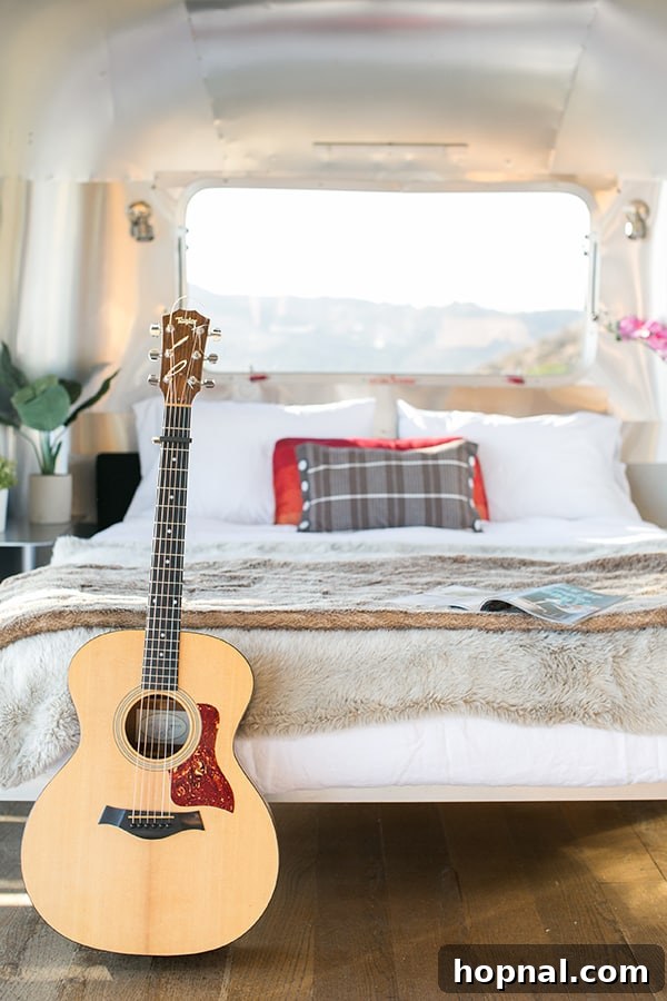 The Art of Airstream Entertaining in Malibu 7 The cozy and inviting interior of the converted Airstream, showcasing a comfortable bed and stylish decor, perfect for luxury camping.