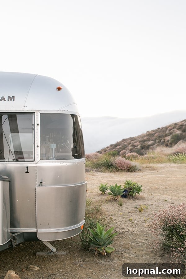 The Art of Airstream Entertaining in Malibu 8 A beautifully illuminated Airstream under the night sky in Malibu, highlighting the magical and secluded setting.