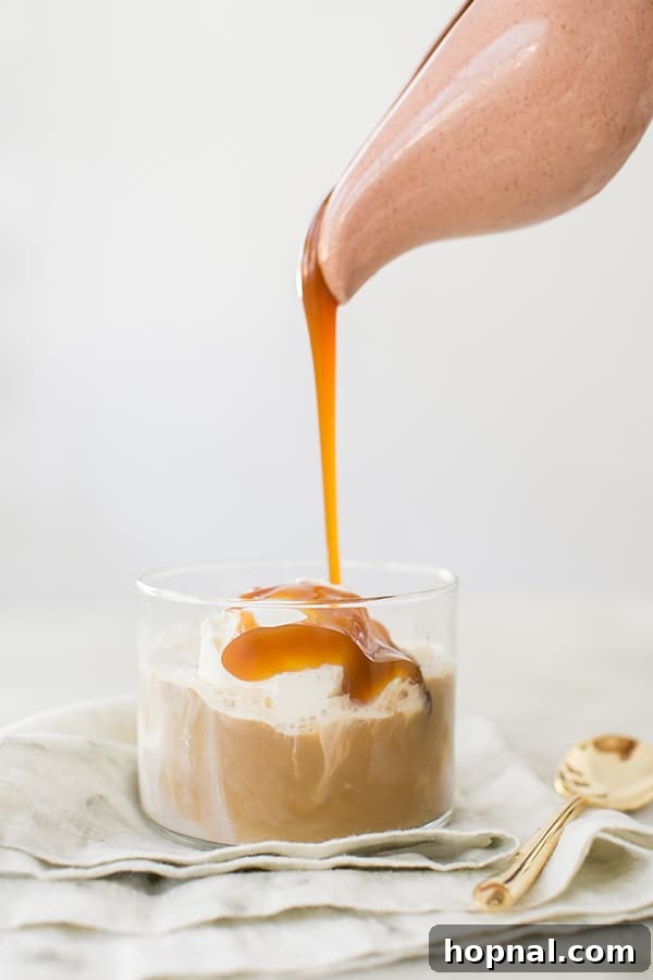 Autumn Spiced Affogato Dream 6 Warm caramel sauce being drizzled artistically into a glass of vanilla ice cream and coffee, enhancing its appeal.