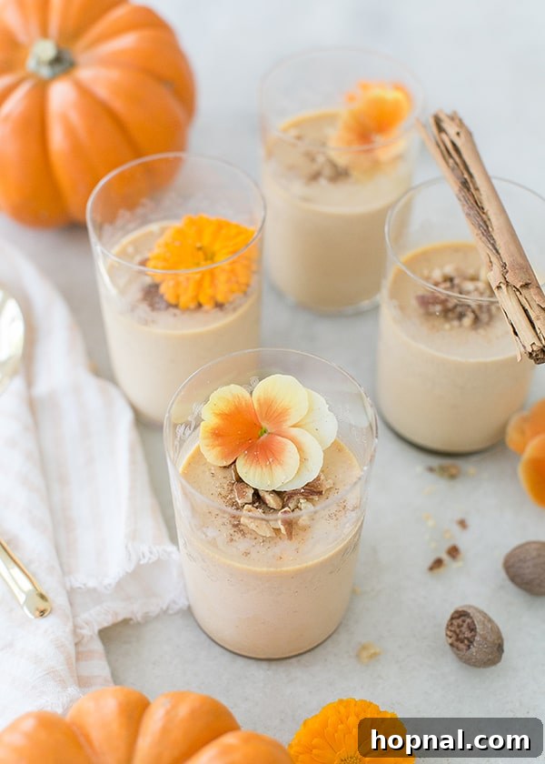 Pumpkin Panna Cotta Perfection 3 A close-up of pumpkin panna cotta, elegantly presented with a touch of fresh orange blossoms.