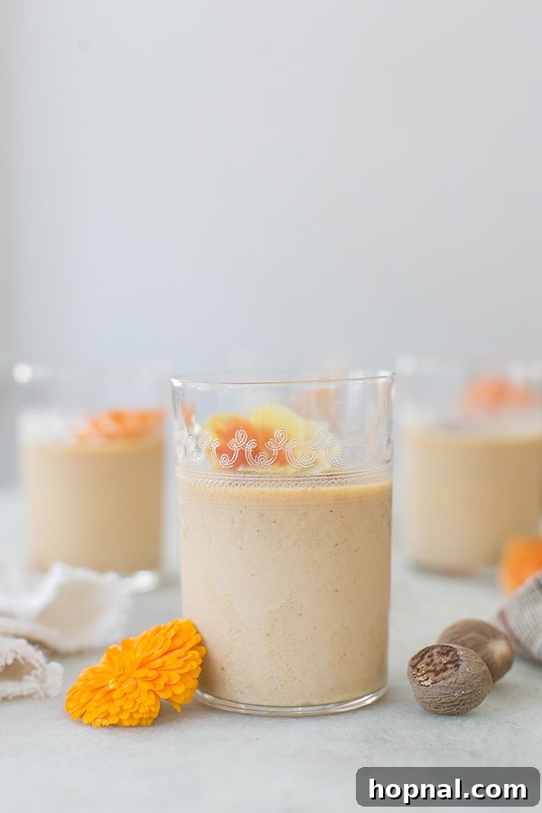 Pumpkin Panna Cotta Perfection 5 A single serving of pumpkin panna cotta in an elegant decorative glass jar, topped with cinnamon and nuts.