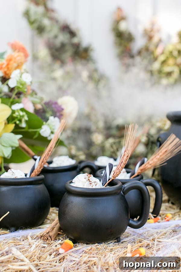 side shot of 4 cauldron mugs with garnish - maple syrup and candy corn