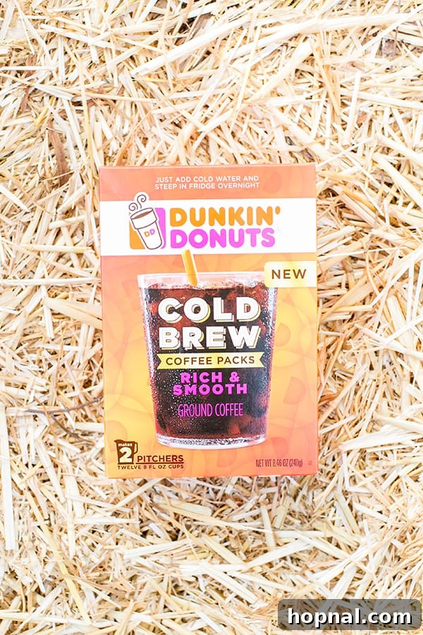 overhead shot of dunkin donuts cold brew pack - mix maple syrup & candy corn, pumpkin spice, halloween coffee
