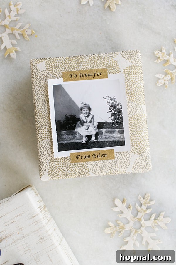 A beautifully wrapped present featuring a personalized photo, secured with gold patterned tape created using the P-touch Embellish.
