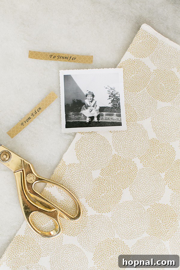 Close-up of a personalized gift with a photo and a gold patterned P-touch Embellish tape label, ready for gifting.