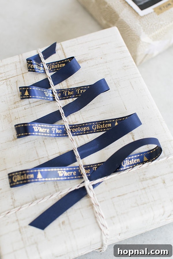 A beautifully wrapped gift featuring a blue custom P-touch Embellish ribbon shaped like a Christmas tree, with song lyrics.