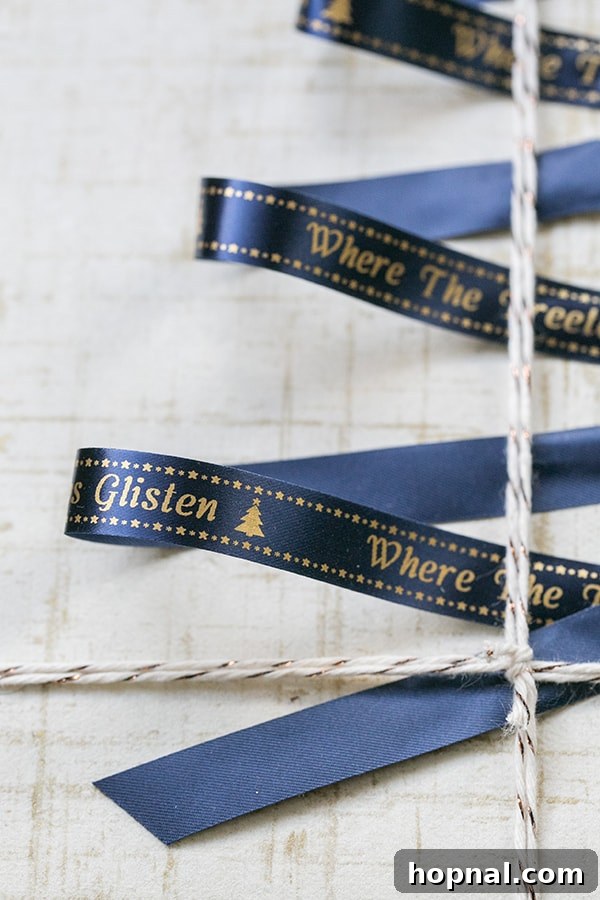 Close-up detail of a blue custom P-touch Embellish ribbon with gold lettering, showcasing the intricate text and quality.
