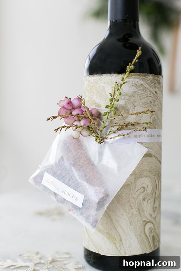 A bottle of red wine adorned with mulling spices and a P-touch Embellish ribbon detailing the recipe, creating a perfect kit.