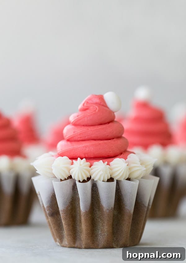 Close-up view of several Santa Hat Cupcakes arranged together, showcasing their festive appeal.